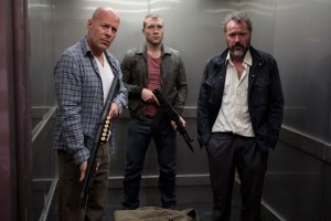A GOOD DAY TO DIE HARD..John McClane (Bruce Willis), Jack McClane (Jai Courtney) and a Russian under their protection, Komarov (Sebastian Koch), take a fateful elevator ride...Photo Credit: Frank Masi, SMPSP..TM & © 2013 Twentieth Century Fox Film Corporation.  All Rights Reserved.  Not for sale or duplication.
